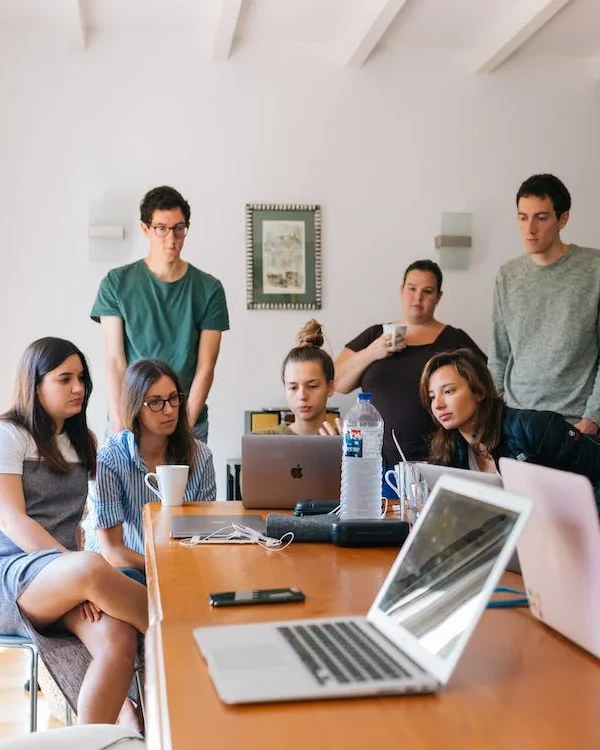 office workers gathering around computer