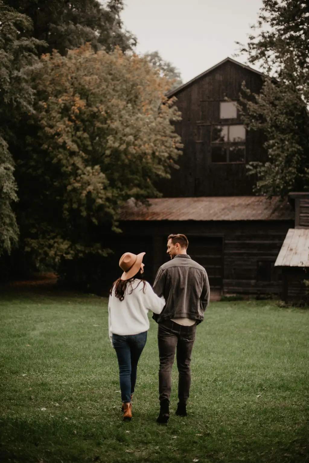 couple in front of old house