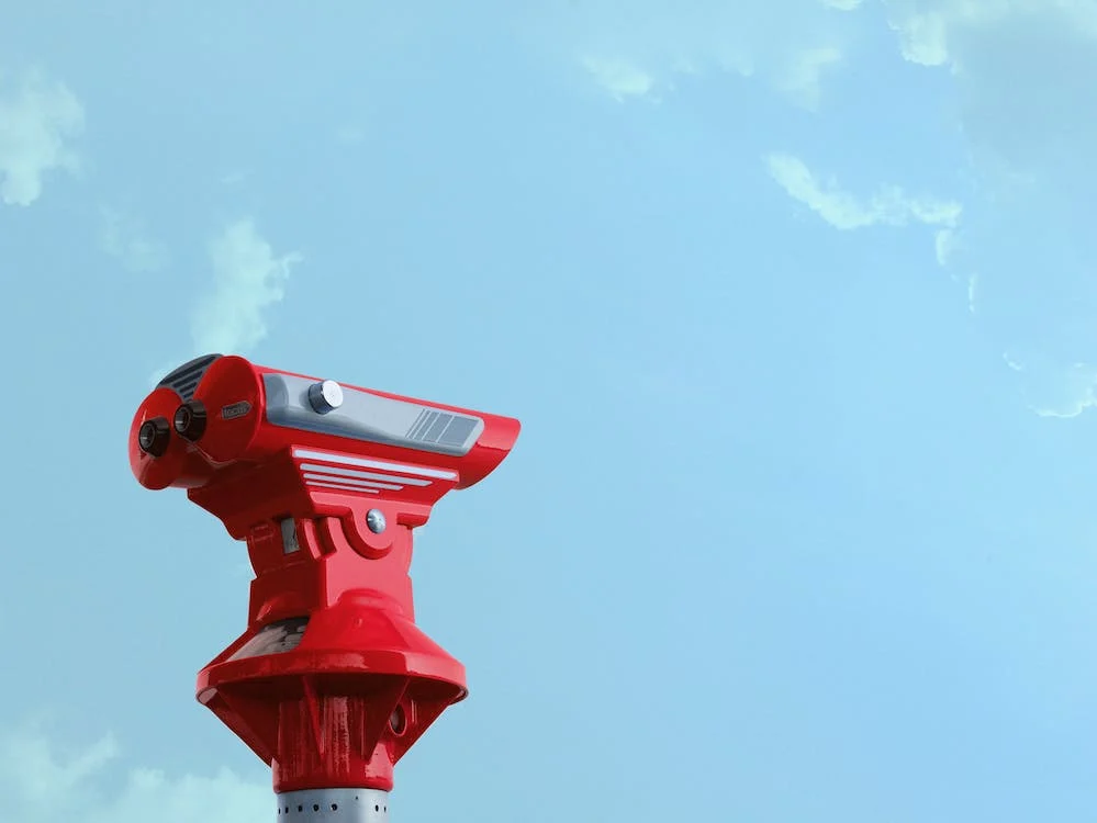 red binoculars under blue sky