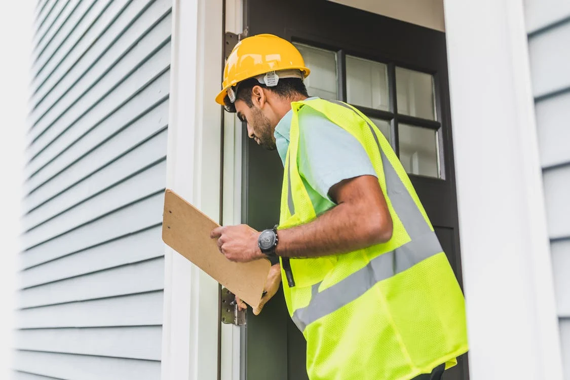 man inspecting house